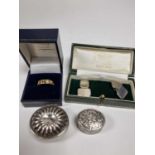 A gold ring, silver cufflinks, and two pill boxes