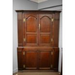 A 19th Century stained oak corner cupboard.