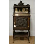 A late Victorian carved mahogany music cabinet and a bed pan.