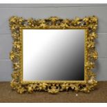 An ornate gilt gesso wall mirror