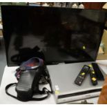 Hisense LED 32in. TV on stand; DVD; and a Canon camera.