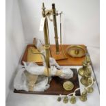 Two sets of brass scales; and a selection of brass weights.