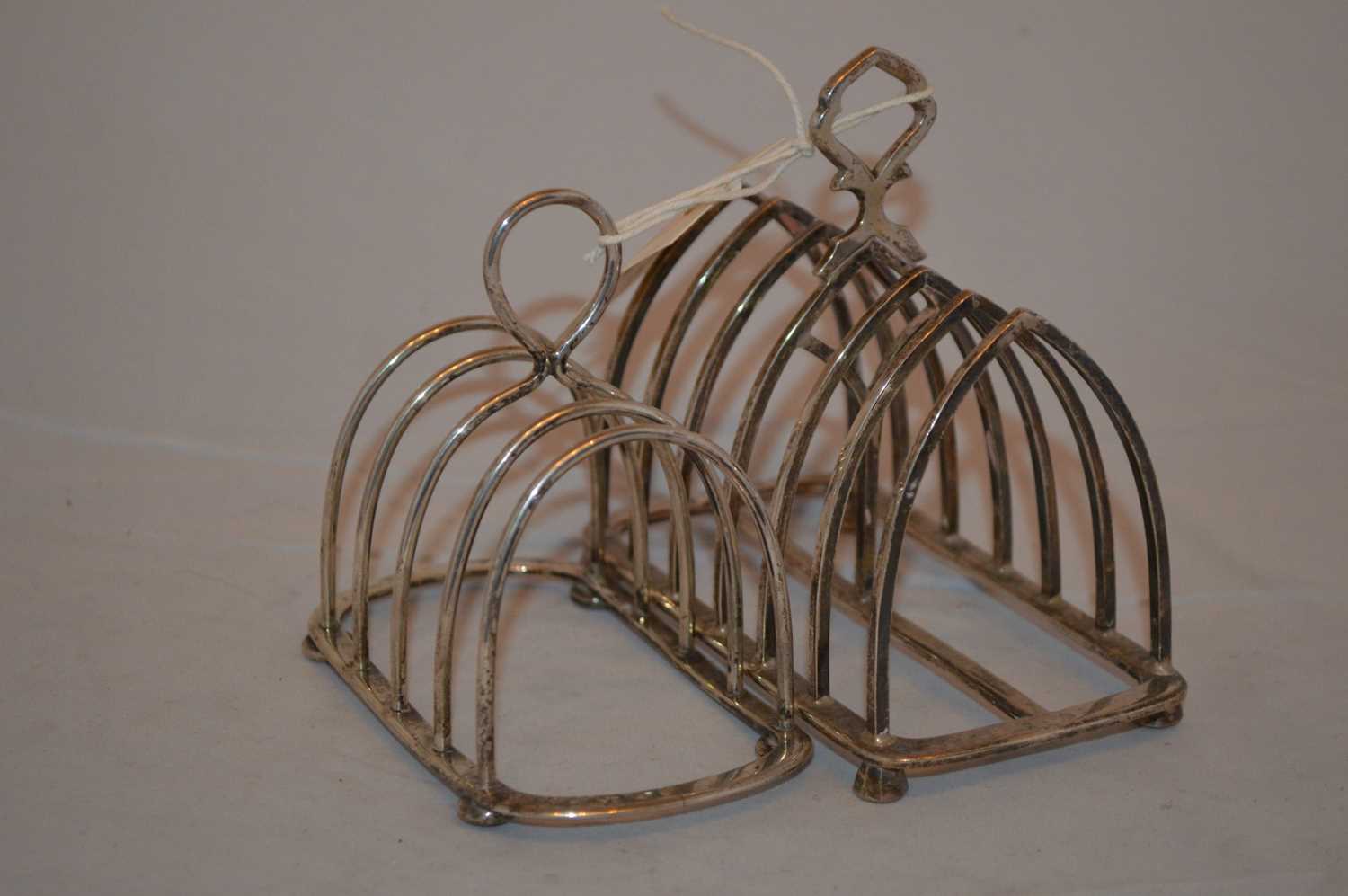 Two silver toast racks,