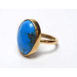 A turquoise ring,