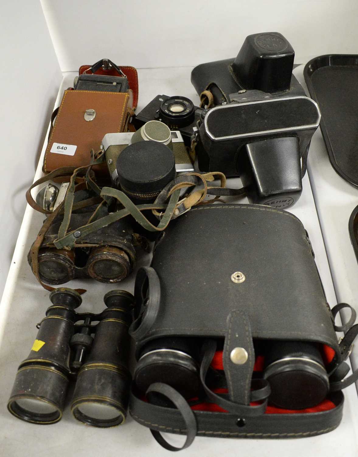 Collection of cameras and monoculars.