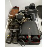 Collection of cameras and monoculars.