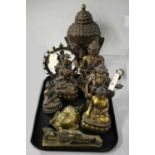 Collection of brass and other Buddha figurines.