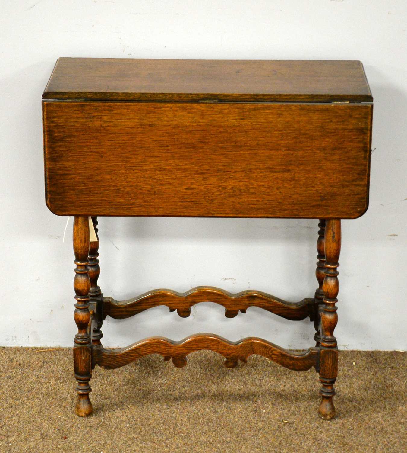 An early 20th Century oak drop leaf tea table