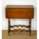 An early 20th Century oak drop leaf tea table