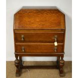 A 1930s oak writing bureau