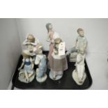A selection of figure Lladro figures; one Nao figure; and another.