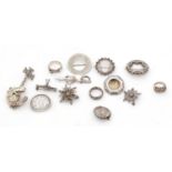 Silver brooches and rings.