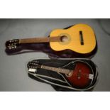 A Palma acoustic guitar; and an Antoria mandolin, both with soft cases.