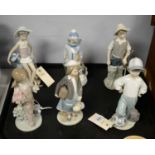 A selection of six Lladro figures of children.