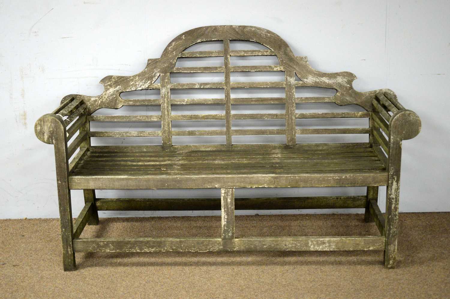 A contemporary teak garden bench