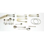 A selection of silver tongs, salt spoons, bangles and other items.