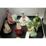 A selection of six Royal Doulton figures of ladies.