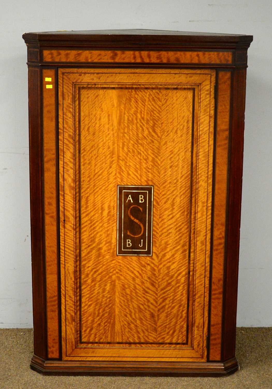 An Edwardian inlaid satinwood corner wall cupboard