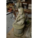 A 20th C stone composite garden ornament of a nude lady.