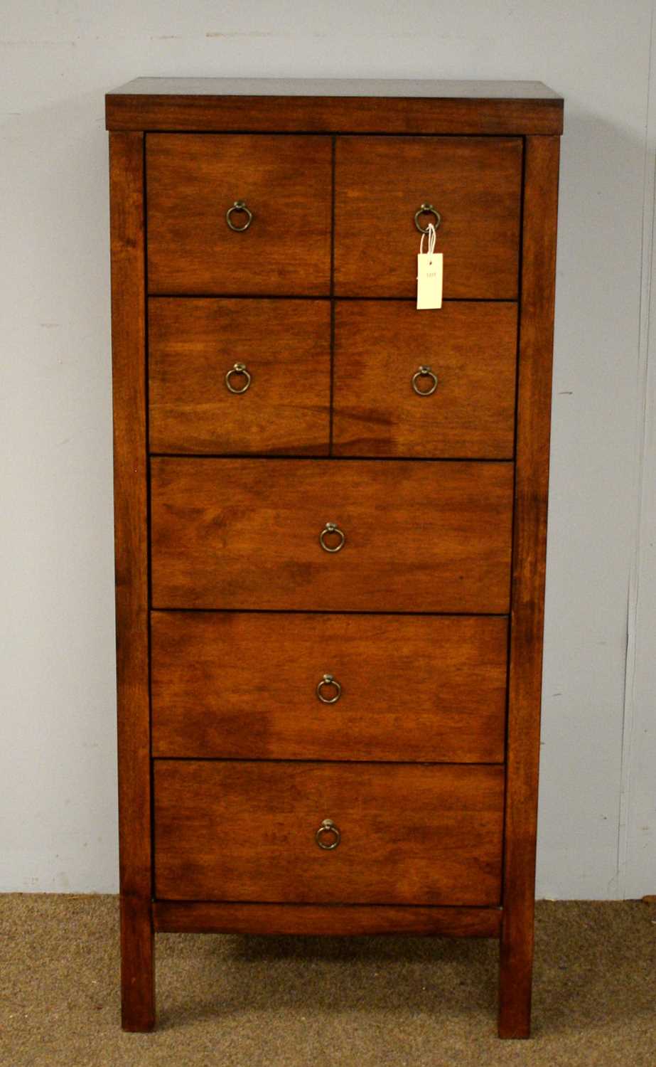 A contemporary stained wood chest of drawers