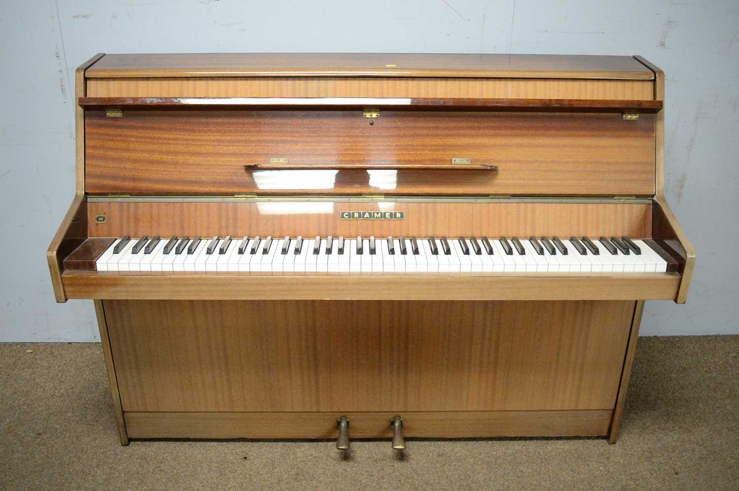 Mahogany-cased upright overstrung piano.