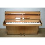 Mahogany-cased upright overstrung piano.