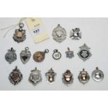 A selection of silver and white metal fobs