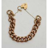 A yellow metal curb link bracelet,