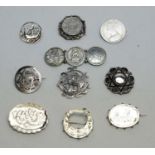 A selection of silver and white metal brooches,