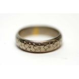 An 18ct white gold wedding band,