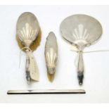 A four piece silver backed dressing table set,