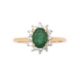 An emerald and white stone ring,