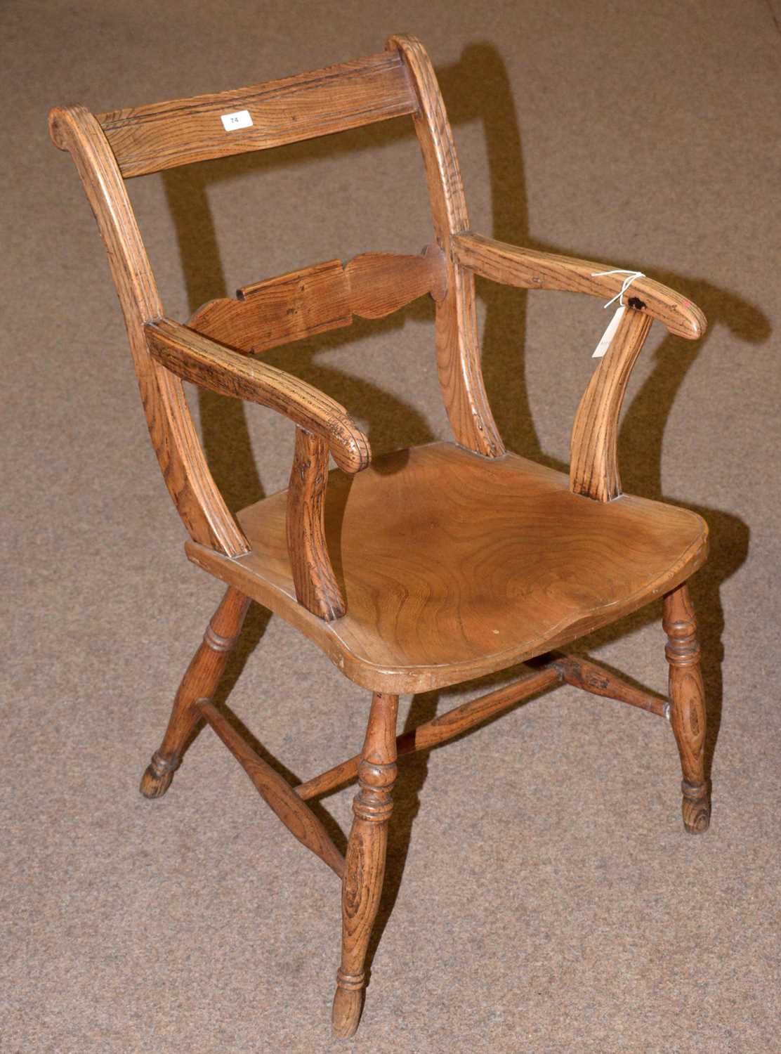 A rustic elm solid seat open armchair.