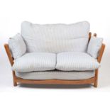 Attributed to Ercol: a modern beech wood two-seater sofa.