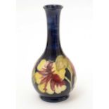 A Moorcroft Hibiscus pattern bottle vase.