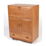 Ercol: An elm Windsor serving cabinet.