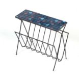A mid-Century wrought metal and Formica magazine rack