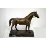 A bronzed figure group of a horse.