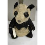 A vintage stuffed panda teddy bear.