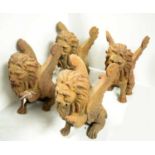 A set of four Roman style cast metal lion gargoyles.