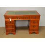 A reproduction yew wood veneered twin pedestal writing desk.