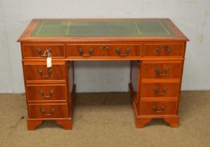 A reproduction yew wood veneered twin pedestal writing desk.