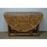 Carved and pokerwork oak drop-leaf table.