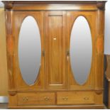 An Edwardian inlaid walnut three door wardrobe.