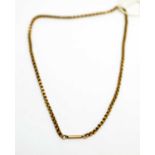 A yellow metal chain necklace,