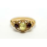 A peridot and red stone ring,