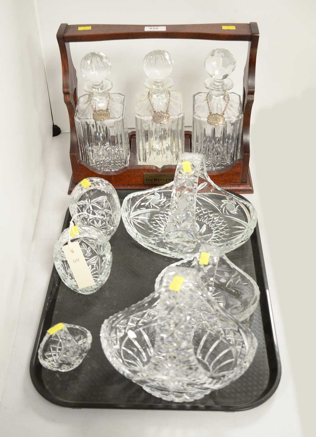 A three-bottle tantalus; and six crystal and cut glass baskets, various.
