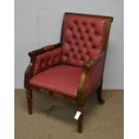 A leaf carved and fluted Georgian-style buttoned-back armchair.