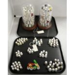 A collection of floral decorated and other ceramic thimbles.