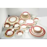A selection of red and gilt decorated dinnerware